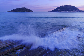 Sunrise at La Concha beach. Waves on La Concha beach at sunrise, city of Donostia San Sebastian, Euskadi.