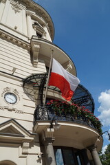 Fototapeta na wymiar Polish flag in the center of Warsaw on a building.