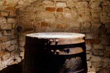 metal rim of a large old wooden barrel in the basement 