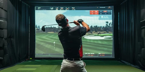 Fototapete Graffiti-Collage Man playing golf on screen in indoor simulator in spacious room with golf club