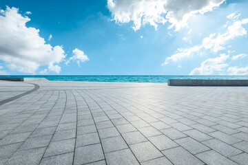 Empty square floor and blue sea with sky clouds background