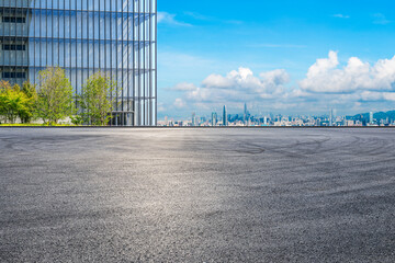 Asphalt road square and glass wall with city skyline in Shenzhen