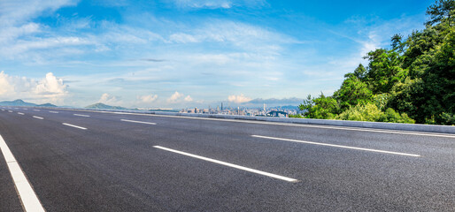 Asphalt highway road and green forest with city skyline in Shenzhen. Panoramic view.