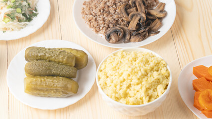 Holy Week, End, Palm Sunday, Good Friday, Easter Sunday Concept. Orthodox food in Great Christian Lent, Lenten food on a wooden table against the background of Orthodox icons.