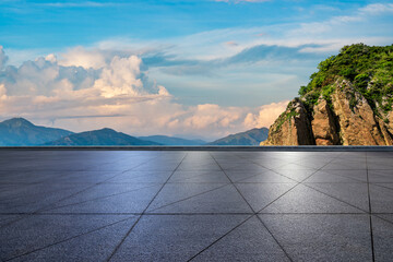 Empty square floor and mountain with sky clouds at sunset
