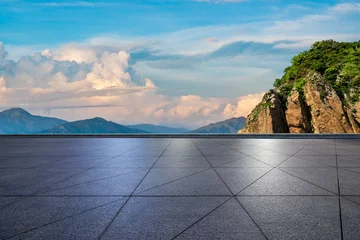 Fototapeten Empty square floor and mountain with sky clouds at sunset © ABCDstock