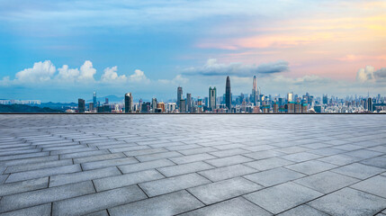 Empty square floors and city skyline with modern buildings at dusk in Shenzhen. Panoramic view.