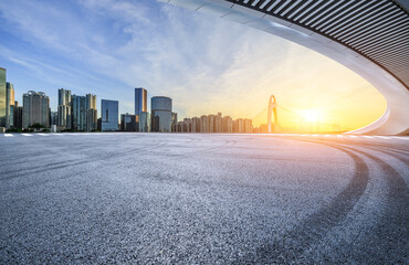 Asphalt road square and bridge with modern city buildings at sunrise in Guangzhou