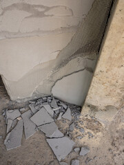 Concrete fragments and foam sheets from broken, damaged walls