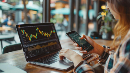 Stock trading investor, trader or broker using crypto exchange platform app on smartphone analysing exchange market chart investing money in financial market on mobile screen with phone and laptop.