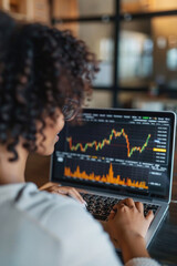 Stock trading investor, trader or broker working analysing exchange market using laptop computer investing money in rising financial market analyzing charts data on computer screen.