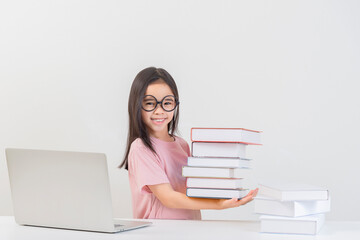 a student on the table and laptop among a large number of books