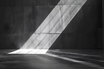 Fotobehang Beam of light in modern concrete room - Dramatic light beam coming through a window in a dark, empty concrete room, creating patterns on the floor © Mickey