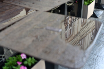 A street with restaurants. Wet tables and chairs. After the rain 