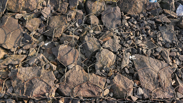 Wire stone texture background. Gravel stone texture. Stone arrangement.Gabion wall caged stones textured background, Retaining wall gabion baskets.