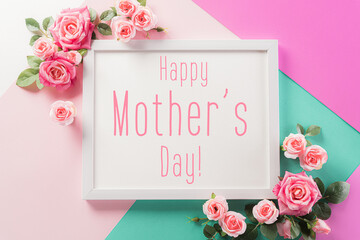 Happy Mother's Day, Women's Day or Valentine's Day greeting concept. Pastel Colours Background with picture frame and pink reses flowers flat lay patterns.