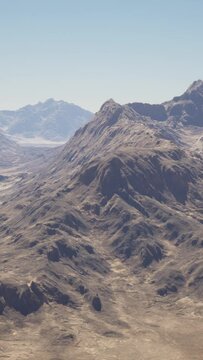 A breathtaking aerial view of majestic mountains in the vast desert landscape