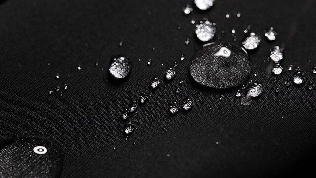 waterproof fabric with waterdrops. non woven fabric water texture background Water drops on waterproof nylon fabric.