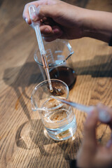 hands holding a pipettes with chemestry