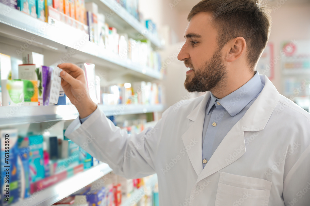 Poster Professional pharmacist near shelves in modern drugstore