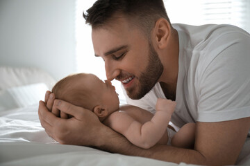 Father with his newborn son at home