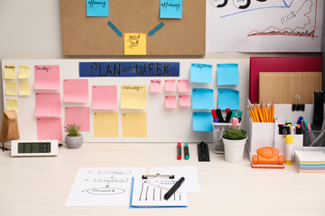 Business process planning and optimization. Workplace with colorful paper notes and other stationery on white wooden table