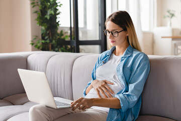 Future mom mother pregnant young caucasian woman watching webinars about pregnancy, e-learning,...