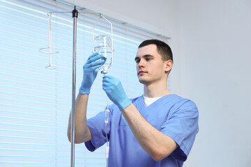 Nurse setting up IV drip in hospital