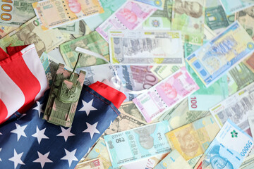 Tank on United States flag on many banknotes of different currency. Background of war funding and...