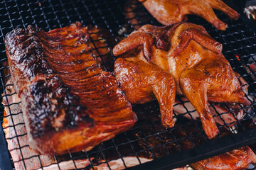 Pork being barbequed in a southern style pit over hickory wood.