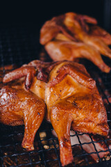 Pork being barbequed in a southern style pit over hickory wood.