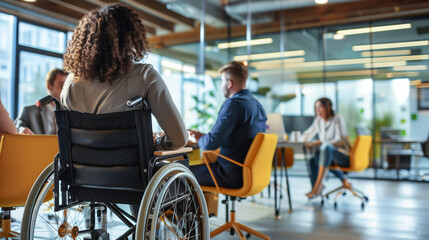 Professionals gather around a table for a meeting, including an individual in a wheelchair, showcasing a workplace that values diversity and accessibility - obrazy, fototapety, plakaty