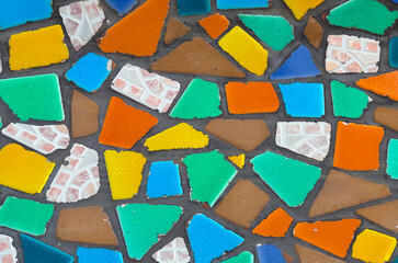 Abstract background of vibrant, broken mosaic tiles arranged in a random pattern