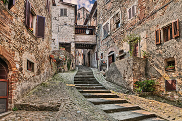 Anghiari, Arezzo, Tuscany, Italy: ancient narrow alley with staircase in the Tuscan medieval village - 761583741