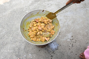 Cooking Goat meat in a Frying Pan on coal Stove at Home Kitchen. Sizzling chunks of juicy Goat meat fillet, with onions. Home delicious food. Make indian Goat meat curry in traditional style.