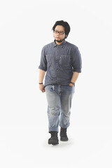 Fototapeta premium full body portrait of an Asian man wearing glasses walking on a white background