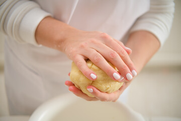 Woman hands kneading dough in the kitchen, close-up. Process of cooking pecan pie in home kitchen for American Thanksgiving Day.