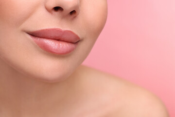 Obraz na płótnie Canvas Woman with beautiful lips on pink background, closeup. Space for text