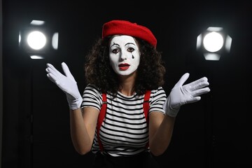 Young woman in mime costume performing on stage