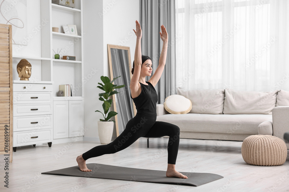 Sticker Girl practicing crescent asana on yoga mat at home. High lunge pose