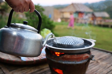 A traditional antique kettle made of aluminum holds a deliciously flavored soup. Pour soup into...