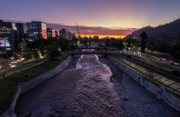 Beautiful aerial Night view of the city of Santiago de Chile, is buildings lighted,the Mopocho river