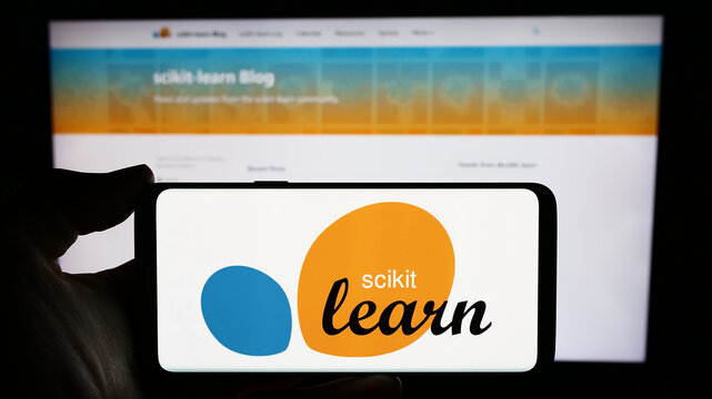 Stuttgart, Germany - 03-08-2024: Person holding mobile phone with logo of software machine learning library scikit-learn in front of web page. Focus on phone display.