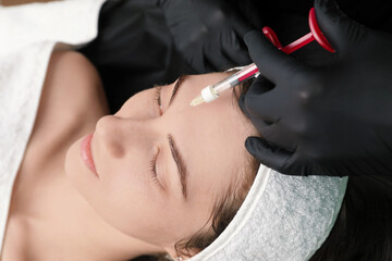 Cosmetologist giving facial injection to patient, closeup. Cosmetic surgery