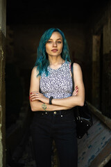 Portrait of a young beautiful slender girl with blue hair.