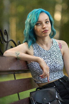 Portrait of a young beautiful slender girl with blue hair.