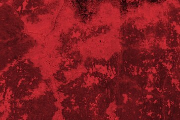 A textured background featuring deep red tones with a distressed, grunge appearance. The surface shows scratches and uneven patterns, creating a vintage feel.