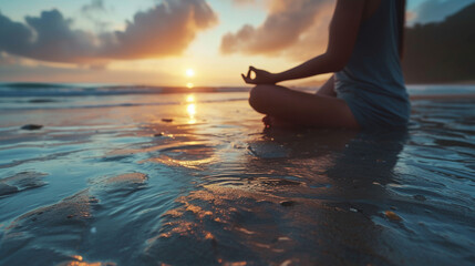 A woman sits in the tailor, sits by the sea at sunset and meditates - obrazy, fototapety, plakaty