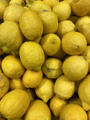 A lot of lemons are in the juice box, ripe, yellow, sweet and sour