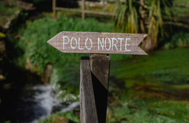 Wooden signpost indicating the North Pole